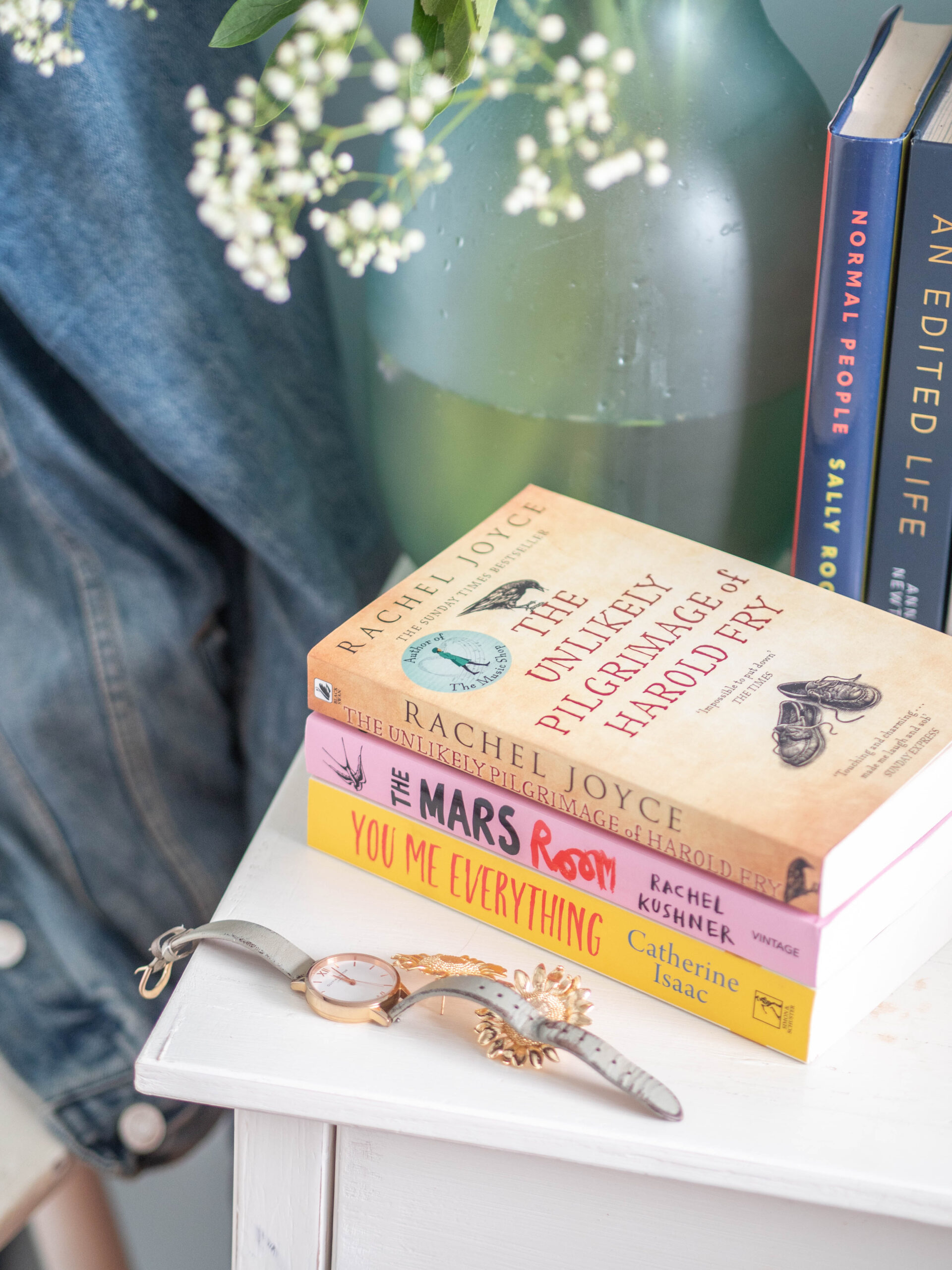 A stack of books on display on a bedside table